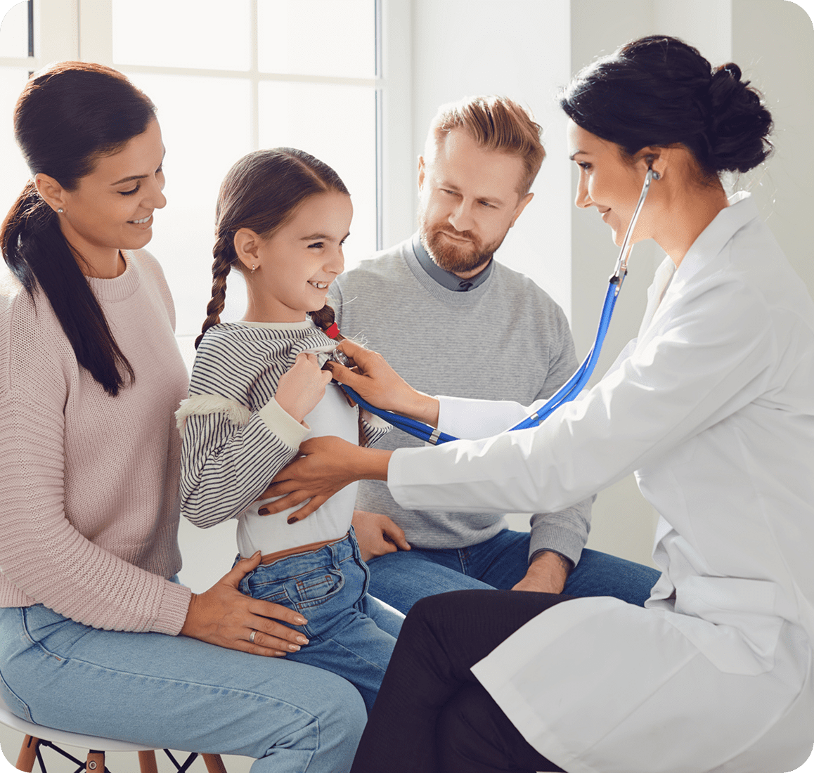 Doctor examining child with stethoscope, family present.